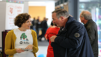 Dervla King from Comhlamh speaking to a member of the public at the 2016 Irish Aid Volunteering Fair