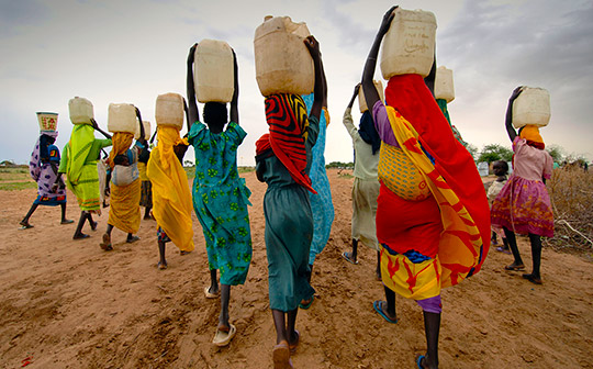 A group of women carrying water 