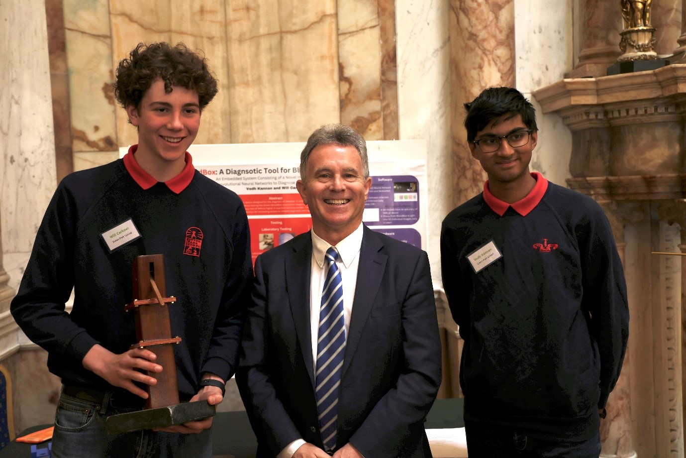 Winners of the Science for Development Award 2023 Will Carkner (left), and Vedh Kannan (right) from Sutton Park School, Dublin pictured with Minister Sean Fleming (center) at the Science for Development showcase 2023.